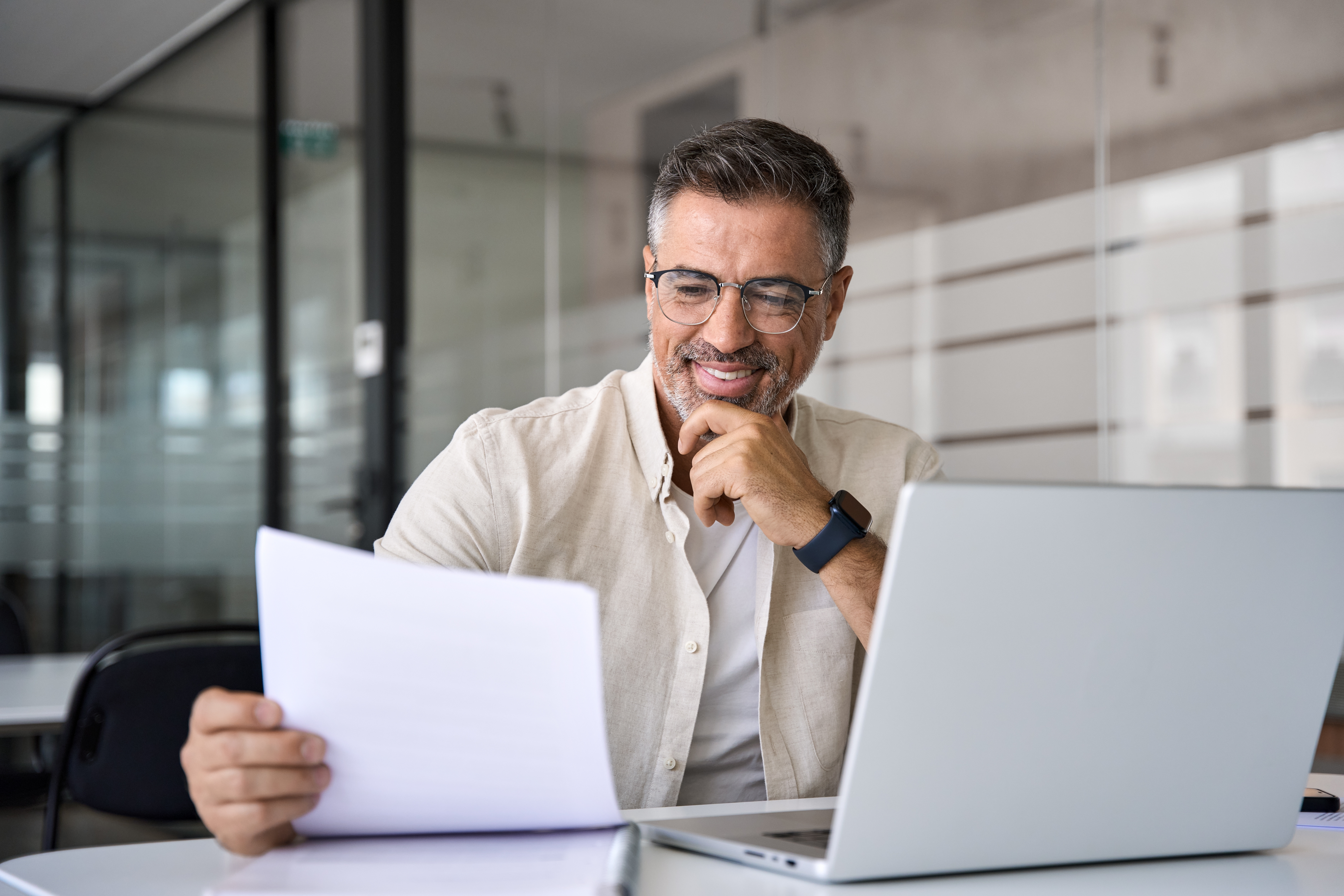 Man looking at general liability insurance papers and smiling